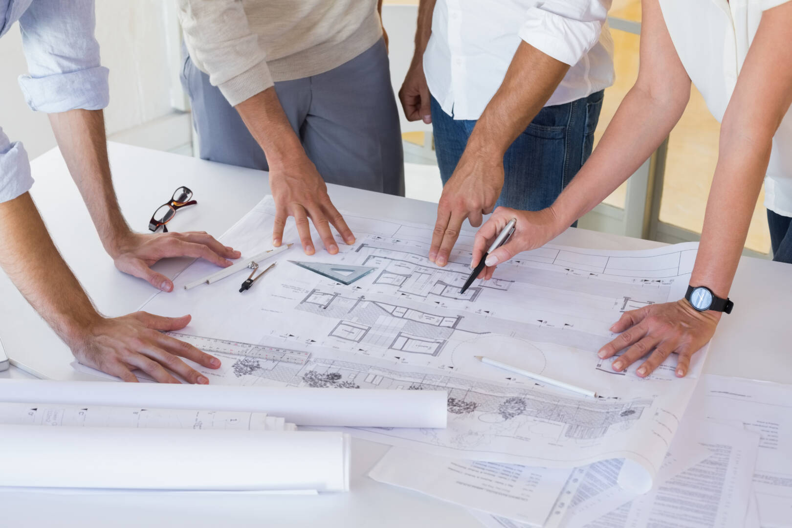 Casual architecture team working together at desk in the office